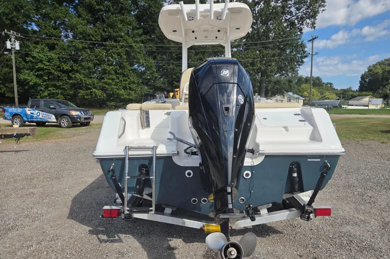 Slide: The Image of 2021 Tidewater 220 LXF boat with outboard motor, parked on gravel lot. - 5
