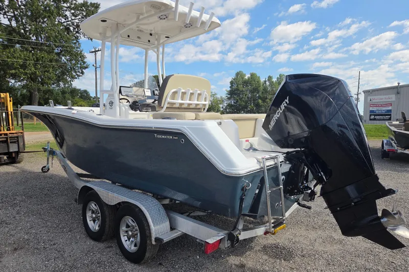 Slide: The Image of 2021 Tidewater 220 LXF boat on trailer with Mercury outboard motor, parked outdoors. - 6