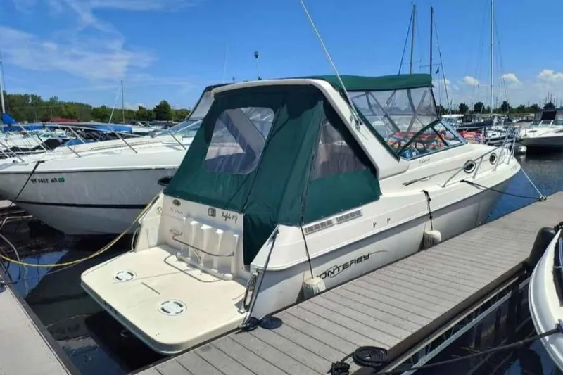 The Image of 2000 Monterey 296 Cruiser docked at marina under clear blue sky. - 1