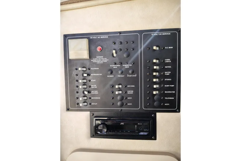 Slide: The Image of Control panel of a 2000 Monterey 296 Cruiser boat with various switches and a JVC stereo. - 10