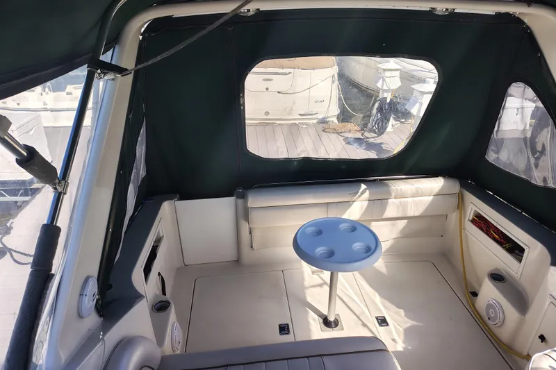 Slide: The Image of Interior of 2000 Monterey 296 Cruiser with seating and table, docked at marina. - 3