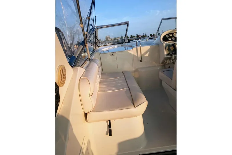 Slide: The Image of Interior of 2000 Monterey 296 Cruiser boat with beige seating and dashboard view. - 4