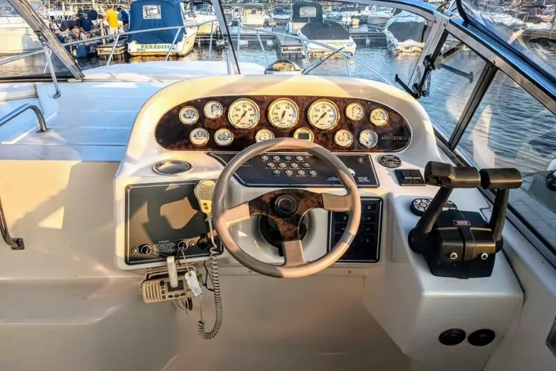 Slide: The Image of Cockpit of 2000 Monterey 296 Cruiser with steering wheel and control panel at marina. - 5