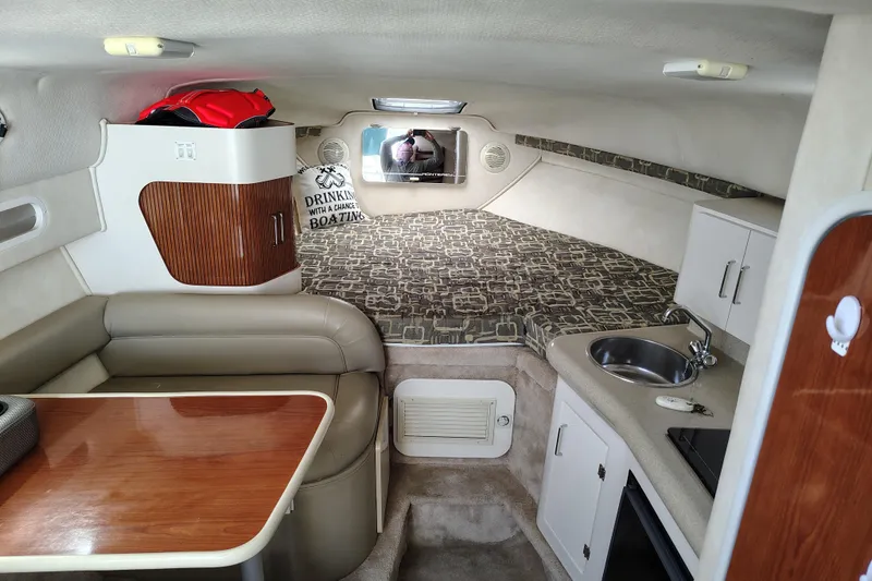 Slide: The Image of Interior of 2000 Monterey 296 Cruiser with seating, kitchenette, and sleeping area. - 6
