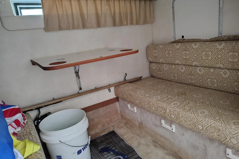 Slide: The Image of Interior of 2000 Monterey 296 Cruiser with patterned seating and foldable table. - 9