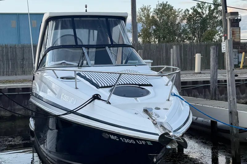 Slide: The Image of 2018 Regal 28 Express boat docked at marina, front view. - 2