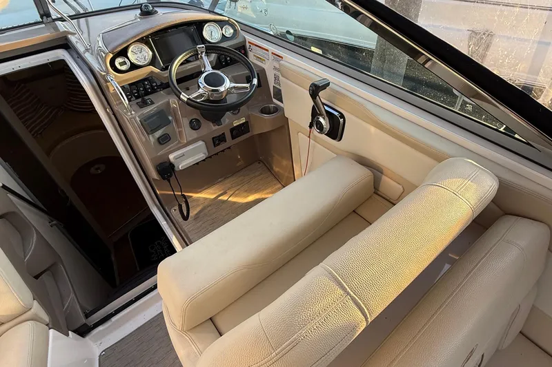 Slide: The Image of Interior view of 2018 Regal 28 Express boat cockpit with steering wheel and controls. - 22
