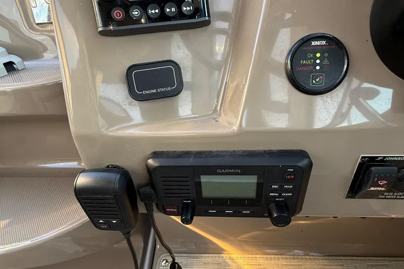 Slide: The Image of Control panel of 2018 Regal 28 Express boat with Garmin device and engine status indicator. - 24