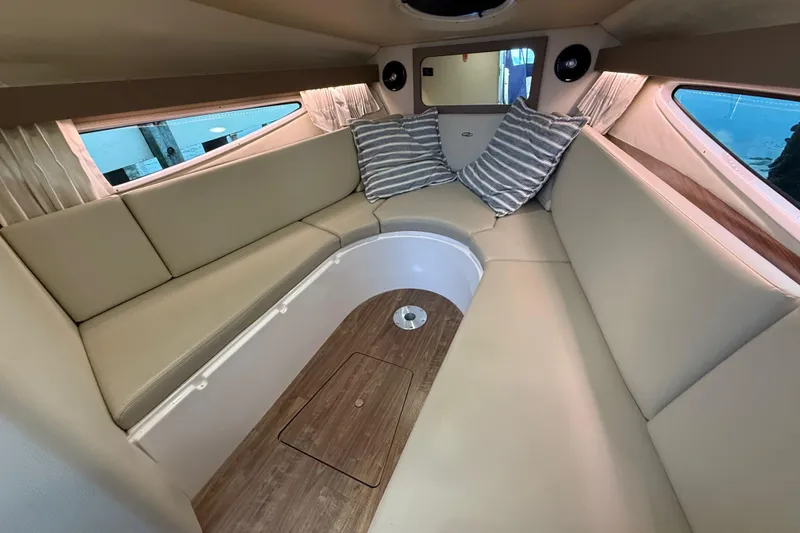 Slide: The Image of Luxurious interior of 2018 Regal 28 Express boat with beige seating and striped pillows. - 25