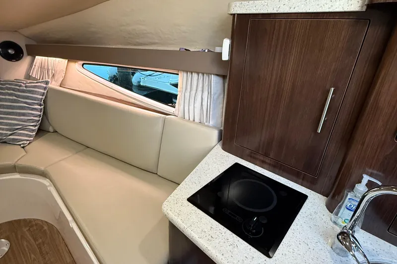 Slide: The Image of Interior of 2018 Regal 28 Express boat with kitchenette and seating area. - 32