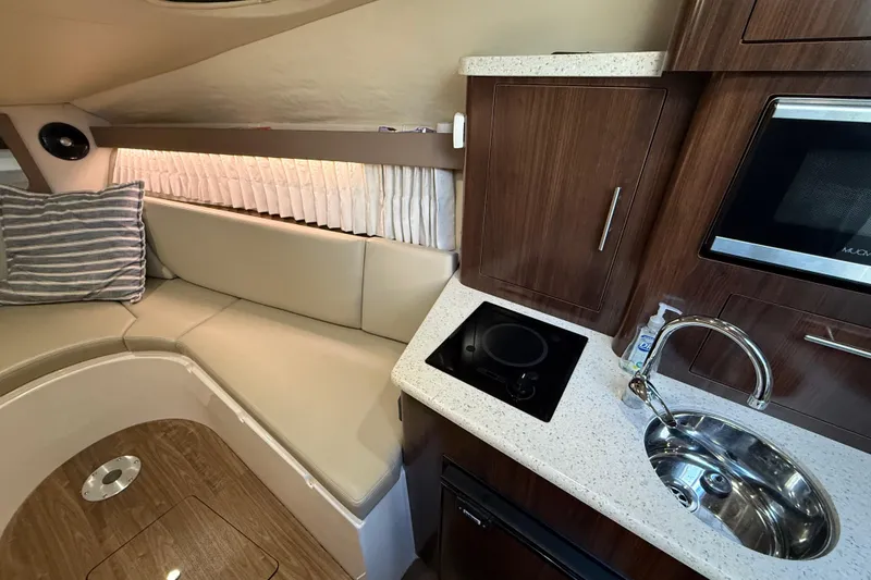 Slide: The Image of 2018 Regal 28 Express cabin interior with kitchenette, seating, and modern amenities. - 33