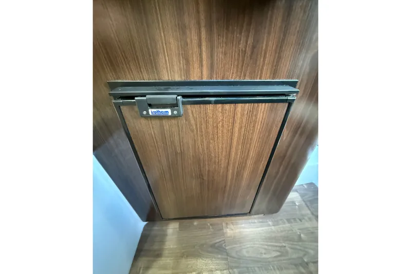 Slide: The Image of Wooden cabinet door inside 2018 Regal 28 Express boat interior. - 35