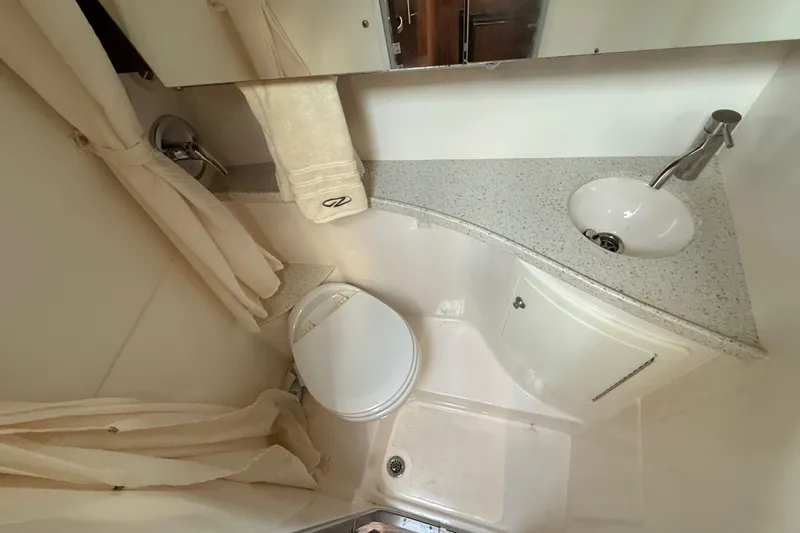 Slide: The Image of Compact bathroom in 2018 Regal 28 Express boat with sink, toilet, and shower. - 39