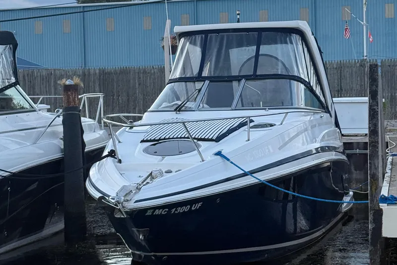 Slide: The Image of 2018 Regal 28 Express boat docked at marina, front view. - 6