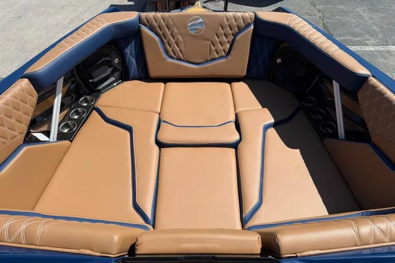 Slide: The Image of Luxurious interior of 2026 Tigé 24RZX boat with tan and blue upholstery. - 15