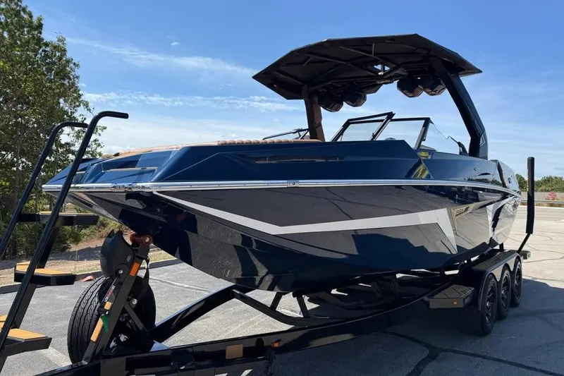 Slide: The Image of 2026 Tigé 24RZX boat on trailer, sleek design, parked outdoors. - 3