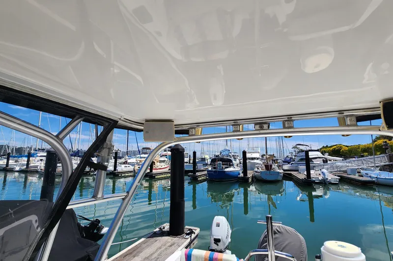 Slide: The Image of Boston Whaler 21 Conquest, 2000 model, docked at a marina with clear blue skies. - 13