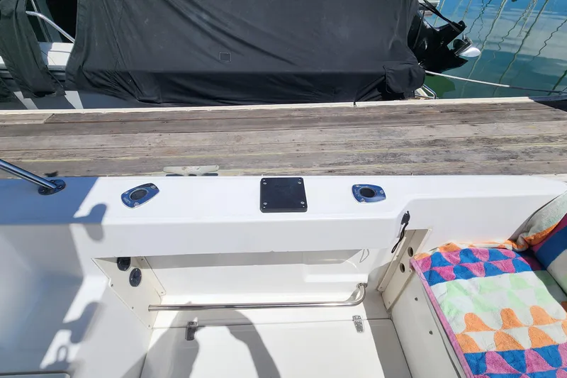 Slide: The Image of Boston Whaler 21 Conquest 2000 boat interior with colorful seating and dock view. - 17