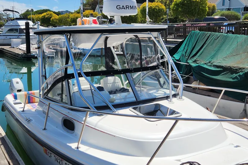 Slide: The Image of Boston Whaler 21 Conquest 2000 boat docked in marina, featuring Garmin equipment. - 4