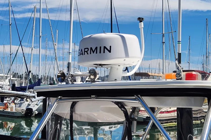 Slide: The Image of Boston Whaler 21 Conquest 2000 with Garmin radar at marina, surrounded by sailboats. - 5