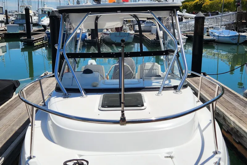 Slide: The Image of 2000 Boston Whaler 21 Conquest boat docked at marina, showcasing sleek design and sturdy build. - 3