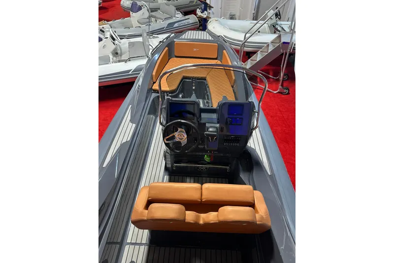 Slide: The Image of 2025 Zar Formenti 59 SL/Limited boat interior with modern dashboard and tan seating. - 13