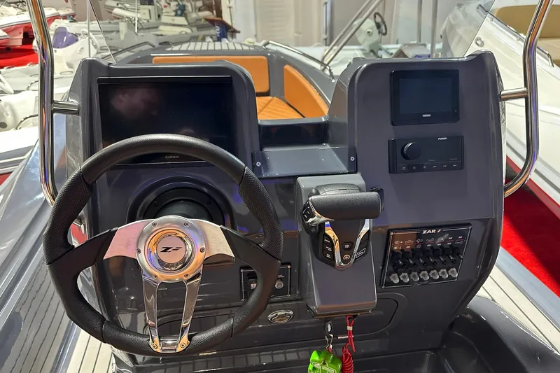 Slide: The Image of 2025 Zar Formenti 59 SL/Limited boat dashboard with steering wheel and control panel. - 14