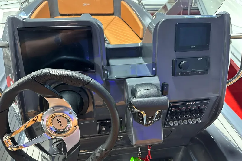 Slide: The Image of Control panel of 2025 Zar Formenti 59 SL/Limited boat with steering wheel and digital displays. - 4