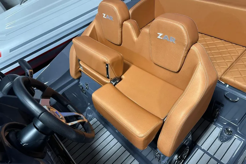 Slide: The Image of 2025 Zar Formenti 59 SL/Limited boat interior with tan leather seats and steering wheel. - 7