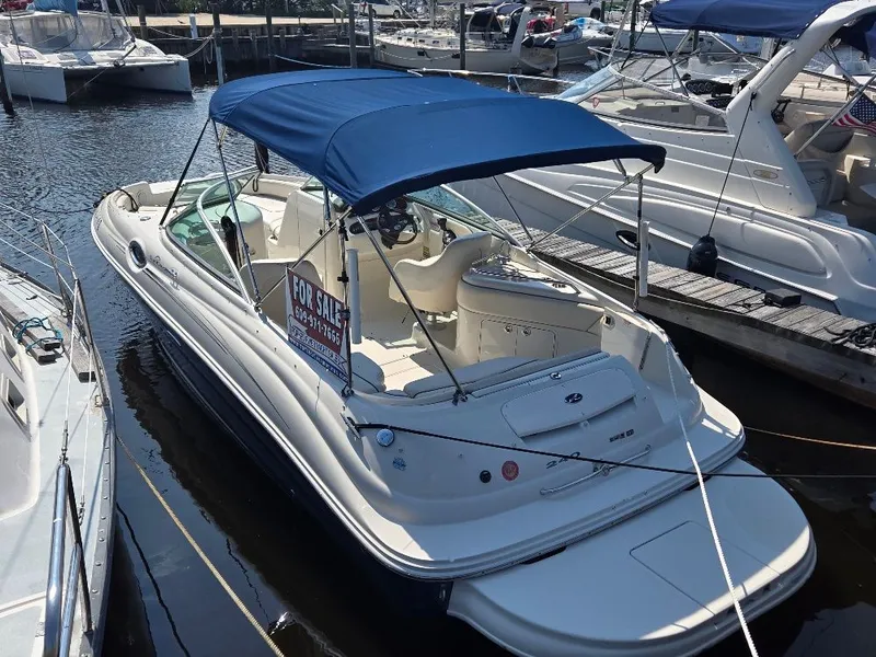 The Image of 2008 Sea Ray 240 Sundeck boat with blue canopy, docked and for sale. - 0