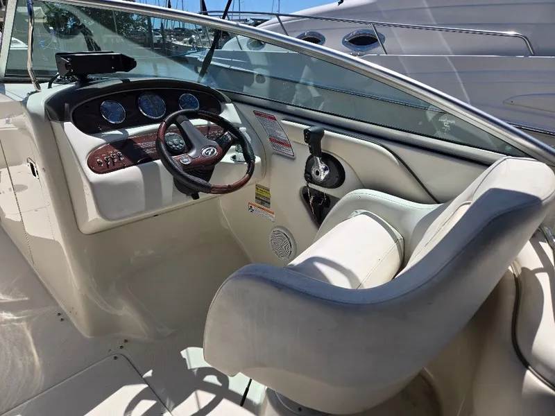 Slide: The Image of 2008 Sea Ray 240 Sundeck boat interior with steering wheel and dashboard controls. - 11