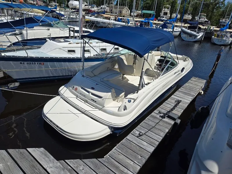 Slide: The Image of 2008 Sea Ray 240 Sundeck boat docked at marina with blue canopy. - 4
