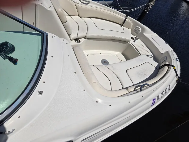 Slide: The Image of 2008 Sea Ray 240 Sundeck boat with spacious seating, docked on calm water. - 5