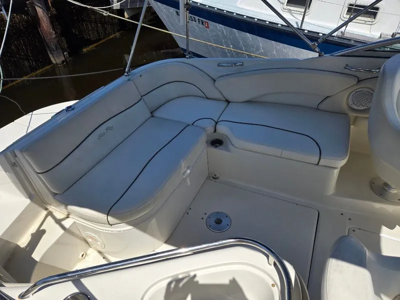 Slide: The Image of 2008 Sea Ray 240 Sundeck interior seating with white upholstery and sleek design. - 6