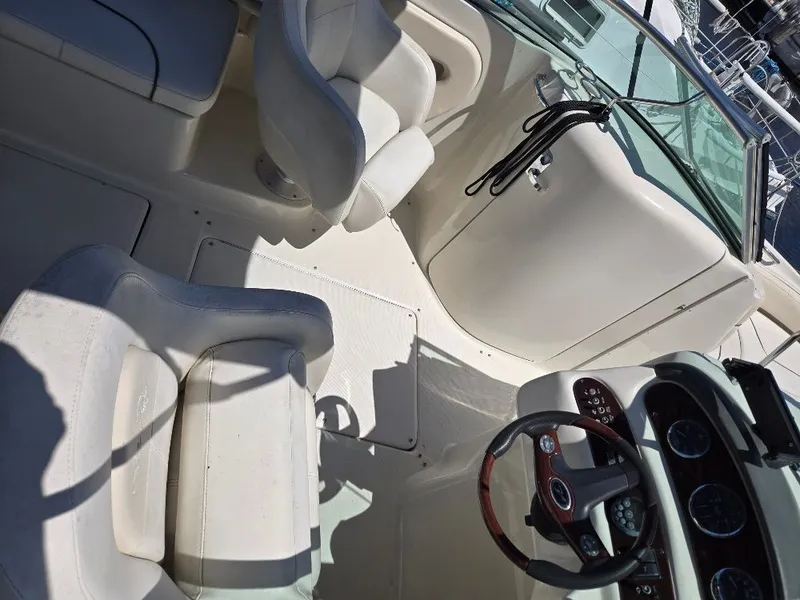 Slide: The Image of 2008 Sea Ray 240 Sundeck interior with steering wheel and seating area. - 7