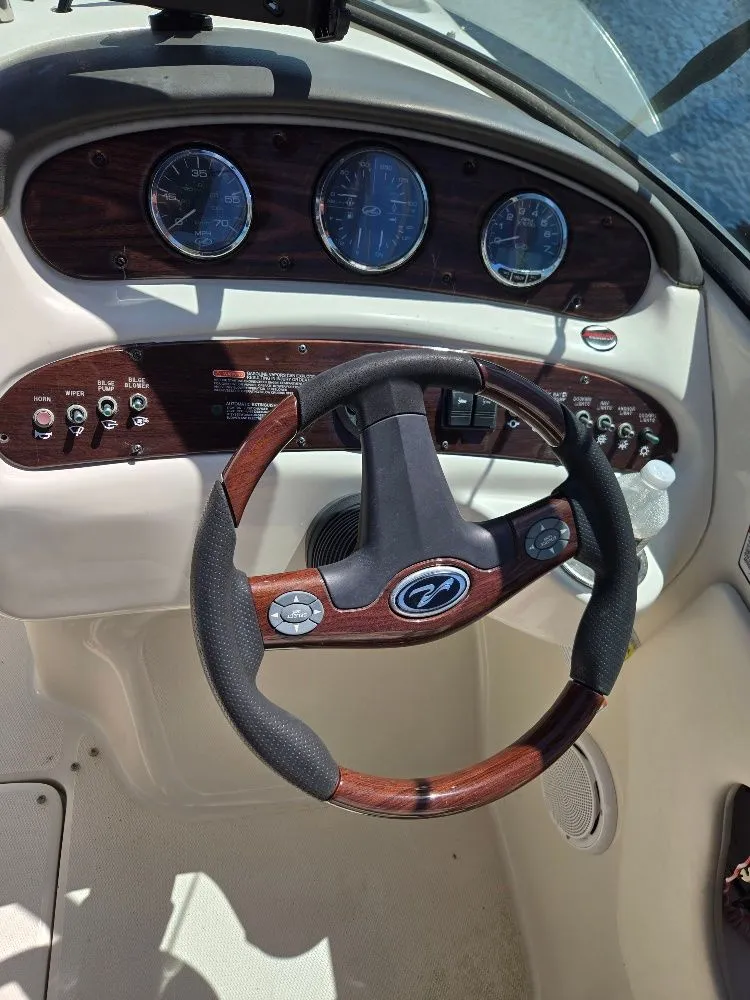 Slide: The Image of Steering wheel and dashboard of a 2008 Sea Ray 240 Sundeck boat. - 9
