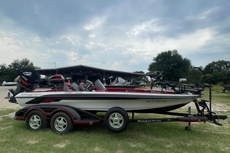 Slide: The Image of 2008 Ranger 520VX boat with Yamaha engine on trailer, parked outdoors. - 2