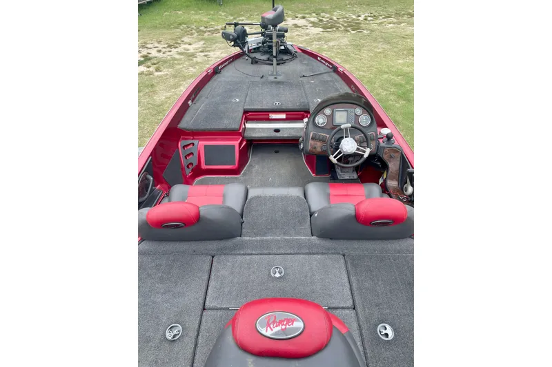 Slide: The Image of 2008 Ranger 520VX boat interior with red and gray seating, steering console, and fishing deck. - 4