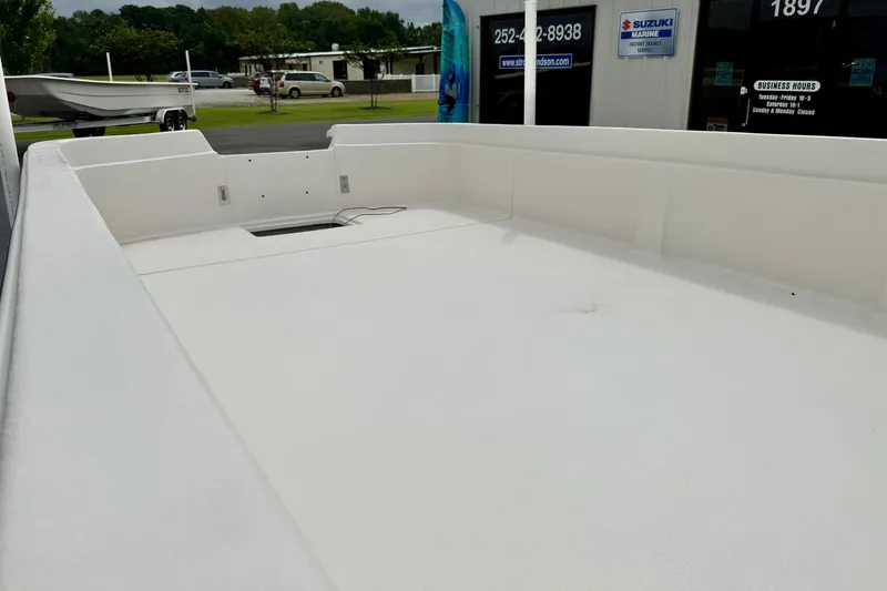 Slide: The Image of 2026 Carolina Skiff E21 DLX Kit Boat interior, showcasing spacious white deck. - 11