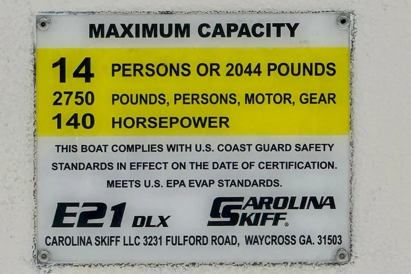 Slide: The Image of 2026 Carolina Skiff E21 DLX Kit Boat capacity plate, 14 persons, 2044 pounds, 140 horsepower. - 16