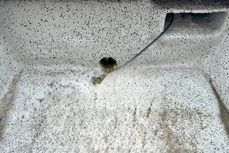 Slide: The Image of Interior of 2026 Carolina Skiff E21 DLX Kit Boat with speckled texture and wiring. - 17