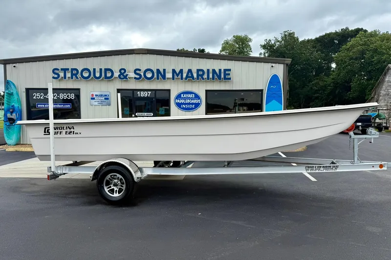Slide: The Image of 2026 Carolina Skiff E21 DLX Kit Boat on trailer at Stroud & Son Marine dealership. - 4