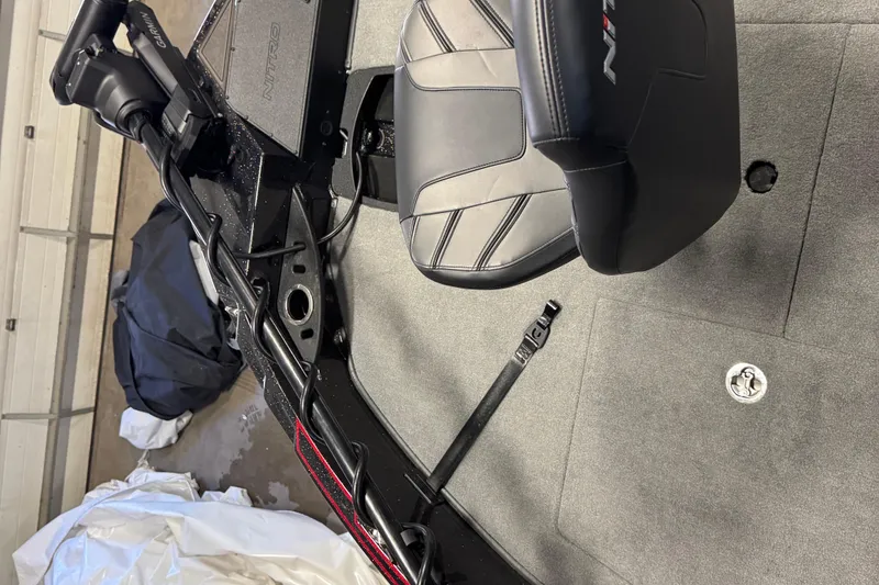 Slide: The Image of 2024 Nitro ZV21 boat interior with black seat and Garmin equipment. - 12