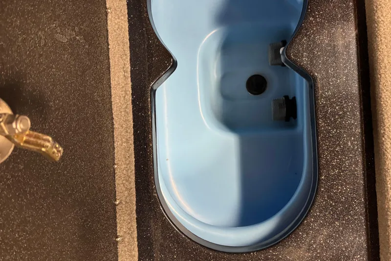 Slide: The Image of 2024 Nitro ZV21 boat livewell with blue interior and black textured exterior. - 15