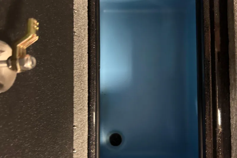 Slide: The Image of 2024 Nitro ZV21 livewell interior with blue lighting and water inlet. - 17