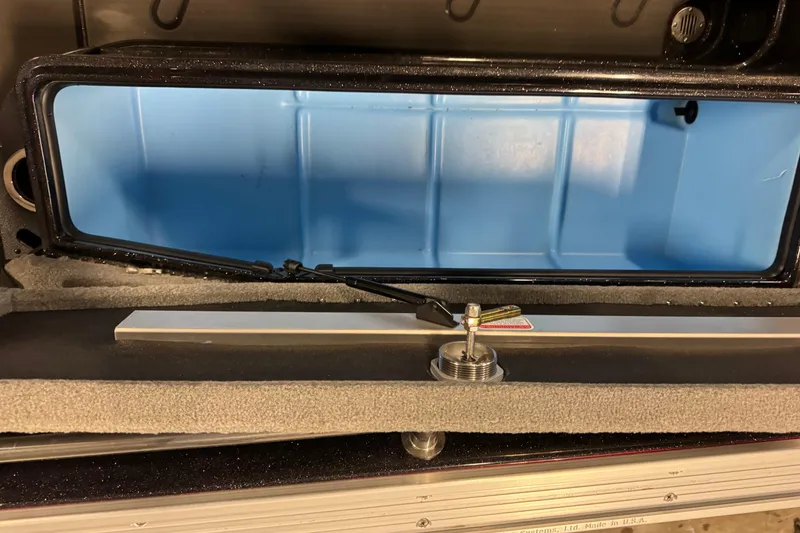 Slide: The Image of 2024 Nitro ZV21 storage compartment with blue interior and secure latch mechanism. - 19