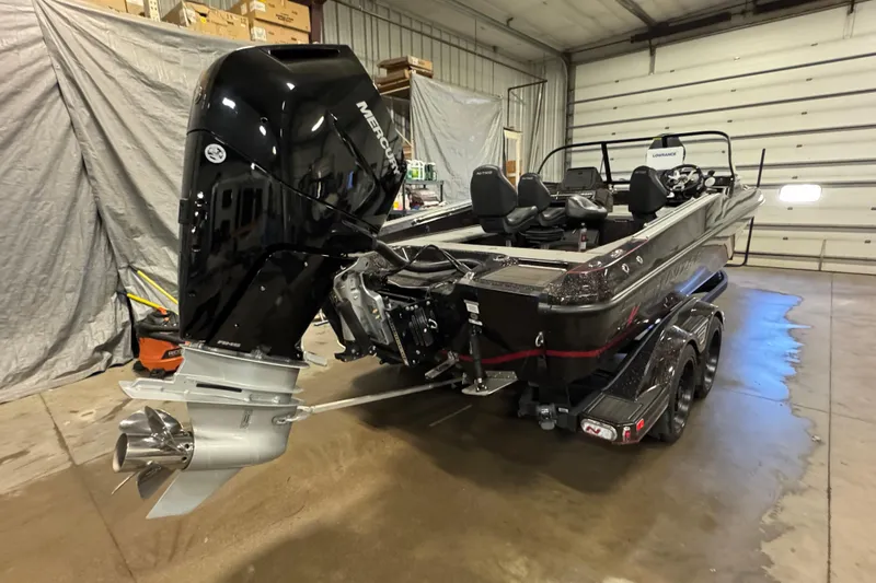 Slide: The Image of 2024 Nitro ZV21 boat with Mercury outboard motor in a garage setting. - 3
