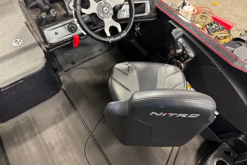 Slide: The Image of 2024 Nitro ZV21 boat interior with steering wheel and branded seat. - 9