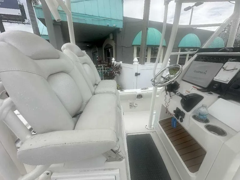 Slide: The Image of 2019 Ranger 2510 Bay Ranger boat interior with white seating and Garmin navigation system. - 4