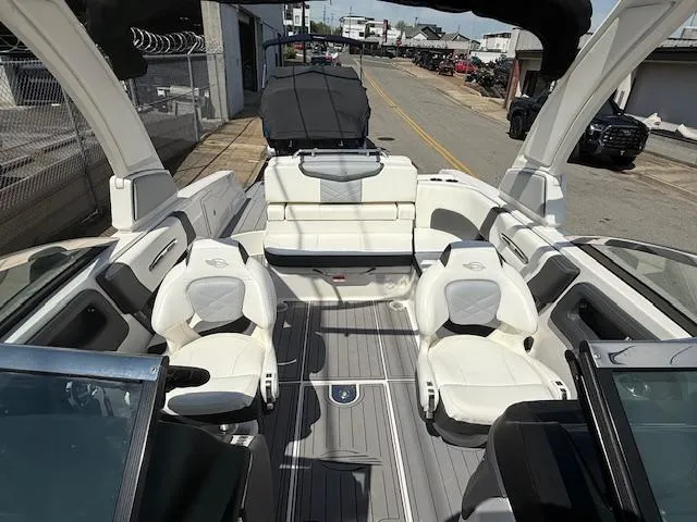 Slide: The Image of 2023 Chaparral 267 SSX boat interior with white seating and sleek design. - 11